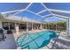Inviting pool area within a screened enclosure and outdoor furniture for enjoyment at 56 Long Meadow Ct, Rotonda West, FL 33947