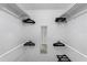A closet with built-in shelves and racks, providing ample storage space for clothing and accessories at 56 Long Meadow Ct, Rotonda West, FL 33947