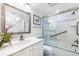 Elegant bathroom featuring a vanity with marble countertop, modern fixtures and a glass shower door at 5700 Gulf Shores Dr # A312, Boca Grande, FL 33921