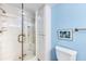 Modern bathroom featuring a glass enclosed shower, built-in cabinets, and a comfortable toilet at 5700 Gulf Shores Dr # A312, Boca Grande, FL 33921