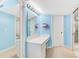 Light blue bathroom with a spacious vanity and a large mirror with Hollywood-style lighting at 5700 Gulf Shores Dr # A312, Boca Grande, FL 33921