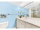 This bathroom boasts a well-lit vanity with a marble countertop and a modern gold faucet at 5700 Gulf Shores Dr # A312, Boca Grande, FL 33921