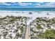 Scenic view of a sandy beach with gentle waves, dunes and inviting walkway to the ocean at 5700 Gulf Shores Dr # A312, Boca Grande, FL 33921
