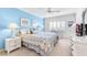 Comfortable bedroom with a blue accent wall, wicker furniture, and a bright, sunny window at 5700 Gulf Shores Dr # A312, Boca Grande, FL 33921