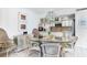 Bright dining area with a glass table, wicker chairs, and a view into the updated kitchen at 5700 Gulf Shores Dr # A312, Boca Grande, FL 33921