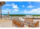 Inviting outdoor seating area with benches and lounge chairs, perfect for enjoying the serene beach view at 5700 Gulf Shores Dr # A312, Boca Grande, FL 33921