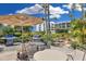 A beautifully landscaped patio with seating, a barbecue grill, and lush greenery for outdoor relaxation at 5700 Gulf Shores Dr # A312, Boca Grande, FL 33921