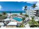 Inviting pool area with palm trees, beach access, and a view of the ocean, perfect for relaxation at 5700 Gulf Shores Dr # A312, Boca Grande, FL 33921