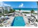 Beautiful community pool with a jacuzzi, lounge chairs, palm trees and a view of the ocean at 5700 Gulf Shores Dr # A312, Boca Grande, FL 33921