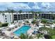 An aerial view showcases the complex pool, jacuzzi, lush landscaping, and the building complex at 5700 Gulf Shores Dr # A312, Boca Grande, FL 33921