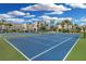 Well-maintained tennis courts with palm trees and condos in the background at 5700 Gulf Shores Dr # A312, Boca Grande, FL 33921