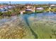 Stunning aerial view showcasing waterfront homes and a dock, highlighting the coastal community at 6029 Manasota Key Rd, Englewood, FL 34223