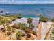 Aerial view showcasing waterfront property and surrounding tropical landscaping with beach access at 6029 Manasota Key Rd, Englewood, FL 34223