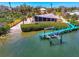 Aerial shot featuring waterfront property with dock, boat lift, and screened in porch at 6029 Manasota Key Rd, Englewood, FL 34223