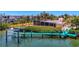 Aerial view of waterfront home, highlighting the private dock and mature landscaping at 6029 Manasota Key Rd, Englewood, FL 34223