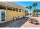 Charming backyard patio with brick flooring, comfortable seating, and lush tropical landscaping at 6029 Manasota Key Rd, Englewood, FL 34223