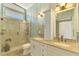 Elegant bathroom featuring double sinks, granite countertops, and a glass-enclosed shower at 6029 Manasota Key Rd, Englewood, FL 34223