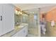 Modern bathroom features a glass-enclosed shower, granite countertops, and updated fixtures at 6029 Manasota Key Rd, Englewood, FL 34223