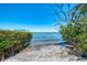 Beautiful beach view with clear water and lush greenery, creating a serene coastal setting at 6029 Manasota Key Rd, Englewood, FL 34223