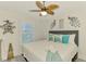 Cozy bedroom with a comfortable bed, stylish decor, shutters, and a ceiling fan at 6029 Manasota Key Rd, Englewood, FL 34223