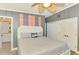 Cozy bedroom with a large bed, neutral colors, and access to a private bath at 6029 Manasota Key Rd, Englewood, FL 34223