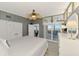 Comfortable bedroom featuring water views, a ceiling fan, and ample closet space at 6029 Manasota Key Rd, Englewood, FL 34223