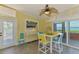 Dining area features access to the water, colorful decor, and coastal artwork at 6029 Manasota Key Rd, Englewood, FL 34223