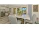 Bright dining area with modern table, chairs, and sliders to a view of the water at 6029 Manasota Key Rd, Englewood, FL 34223