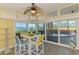Dining area features sliding doors to a screened-in pool, with views of the waterfront at 6029 Manasota Key Rd, Englewood, FL 34223
