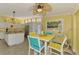 Bright dining area features colorful decor, modern lighting, and an adjacent kitchen with stainless appliances at 6029 Manasota Key Rd, Englewood, FL 34223