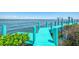 Dock with boat lift, featuring clear blue water, perfect for boating and waterfront activities at 6029 Manasota Key Rd, Englewood, FL 34223