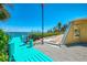 Turquoise dock leading to waterfront property and blue ocean, creating inviting coastal living at 6029 Manasota Key Rd, Englewood, FL 34223