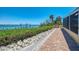 Scenic walkway to a private dock with lush landscaping, offering direct access to the water at 6029 Manasota Key Rd, Englewood, FL 34223