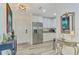 Bright entryway showcasing stylish decor, stainless steel refrigerator, and modern lighting at 6029 Manasota Key Rd, Englewood, FL 34223
