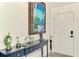 Elegant foyer with console table, artwork, and modern front door, beautifully designed at 6029 Manasota Key Rd, Englewood, FL 34223