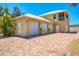 Home with three-car garage, spacious paver driveway, and inviting curb appeal at 6029 Manasota Key Rd, Englewood, FL 34223