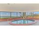 Relaxing indoor pool area boasts waterfront views through large windows, creating a serene and inviting atmosphere at 6029 Manasota Key Rd, Englewood, FL 34223