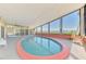 Bright indoor pool area with waterfront views, complete with comfortable seating for relaxation and enjoyment at 6029 Manasota Key Rd, Englewood, FL 34223