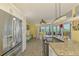 Open kitchen boasts granite countertops, stainless steel appliances, and sunlit breakfast nook with water views at 6029 Manasota Key Rd, Englewood, FL 34223