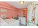 Unique laundry and bathroom featuring a whimsical monkey shower curtain, shelves and storage space at 6029 Manasota Key Rd, Englewood, FL 34223