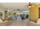 Spacious living area featuring tiled floors, comfortable seating, and water views at 6029 Manasota Key Rd, Englewood, FL 34223