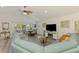 Open-concept living room with a large sectional, dining area, and scenic views at 6029 Manasota Key Rd, Englewood, FL 34223