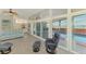 Open-concept living area with waterfront views, comfortable seating, and access to the pool at 6029 Manasota Key Rd, Englewood, FL 34223