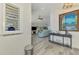 Well-lit living room with stylish decorations, ceiling fan, and luxury flooring at 6029 Manasota Key Rd, Englewood, FL 34223