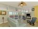 Bright living room with pool view, featuring a comfortable seating area and a ceiling fan at 6029 Manasota Key Rd, Englewood, FL 34223