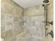 Tiled shower featuring a rainfall showerhead and built in shower caddy at 6029 Manasota Key Rd, Englewood, FL 34223