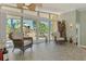 Bright sunroom featuring comfortable seating and scenic views of the lush landscaping at 6029 Manasota Key Rd, Englewood, FL 34223