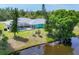 Aerial view of home with screened in pool and backyard on canal at 6062 Spinnaker Blvd, Englewood, FL 34224
