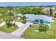 Wide aerial view captures the home's setting with lush landscaping and proximity to local roads at 6062 Spinnaker Blvd, Englewood, FL 34224