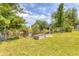 Green backyard with a canal and planted garden beds at 6062 Spinnaker Blvd, Englewood, FL 34224